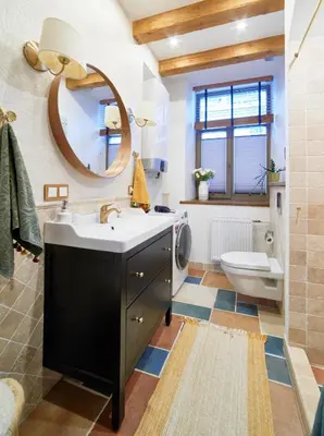 a bathroom with a sink and a toilet and a mirror at Luxury OldTown Free Parking in Vilnius