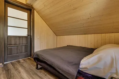 a bedroom with a bed in a room with a window at Kaimo turizmo sodyba „Šerno slėnis“ in Vėdariai