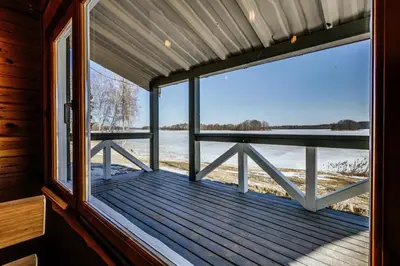a window in a cabin with a view of the water at Kaimo turizmo sodyba „Šerno slėnis“ in Vėdariai