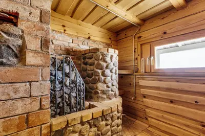 a room with a stone wall and a window at Kaimo turizmo sodyba „Šerno slėnis“ in Vėdariai