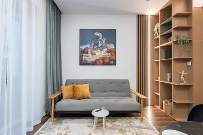 a living room with a couch and a table at cohost I New Bastėja Life Apartments w-Garage Prkg & Self Check-in in Vilnius
