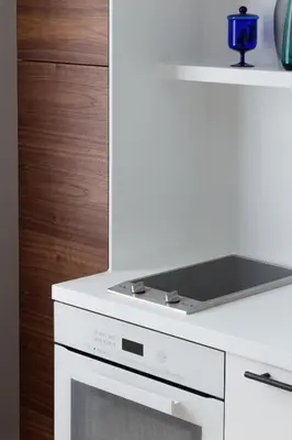 a kitchen with a white stove and a white oven at Design Studio Apartment with Balcony by Domvia in Kaunas