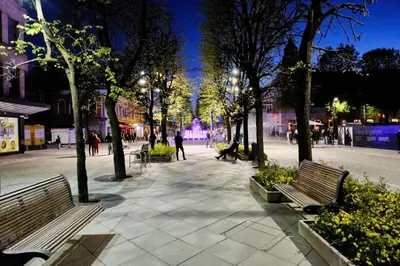 a park with benches and trees at night at Design Studio Apartment with Balcony by Domvia in Kaunas