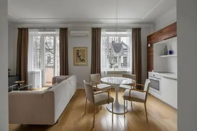 a living room with a couch and a table and chairs at Design Studio Apartment with Balcony by Domvia in Kaunas