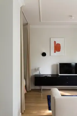 a living room with a couch and a television at Design Studio Apartment with Balcony by Domvia in Kaunas