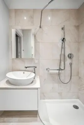a white bathroom with a sink and a shower at Design Studio Apartment with Balcony by Domvia in Kaunas