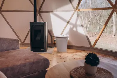 a room with a couch and a table in a yurt at VasaRojaus Kupolai in Birštonas