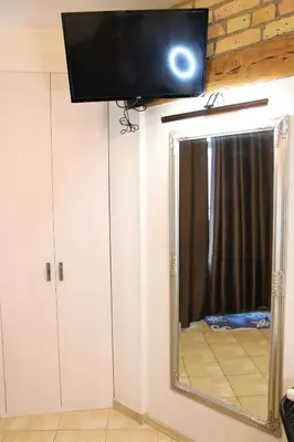 a television on top of a mirror in a room at Cozy apartment in Jeruzalė in Vilnius