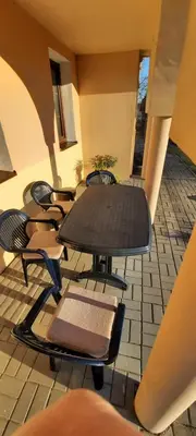 a group of chairs and a table on a patio at Šeimos Būstas Homestay in Šiauliai