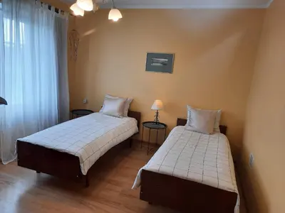 a bedroom with two beds and a window at Šeimos Būstas Homestay in Šiauliai