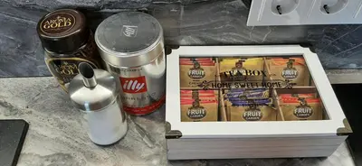 a box of cinnamon sticks and a can of coffee at Familia Apartments in Vilnius