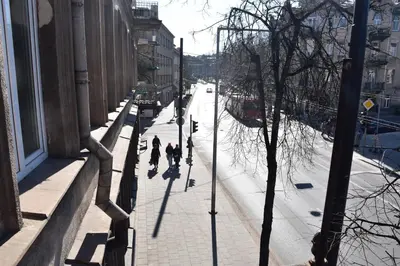 a group of people walking down a city street at Familia Apartments in Vilnius