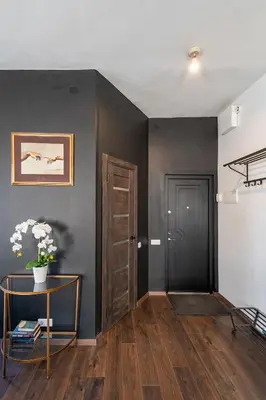 a room with a table and a black wall at Retro Studio Old Town Apartment by Domvia in Kaunas