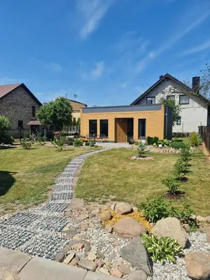 a house with a stone path in front of it at Sipis House in Šiauliai