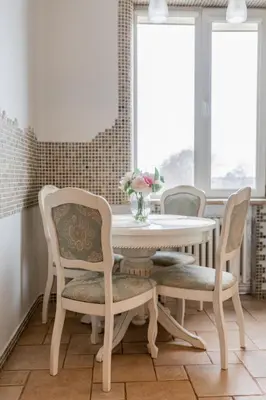 a dining room with a white table and chairs at E. D. Angel Wing Apartment in Šiauliai