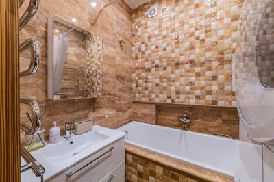 a bathroom with a white tub and a sink at E. D. Angel Wing Apartment in Šiauliai