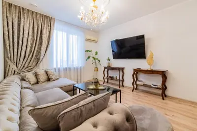 a living room with a couch and a tv at E. D. Angel Wing Apartment in Šiauliai