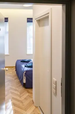 an open door to a bedroom with a bed at HOT SPOT Vilnius Apartments! in Vilnius