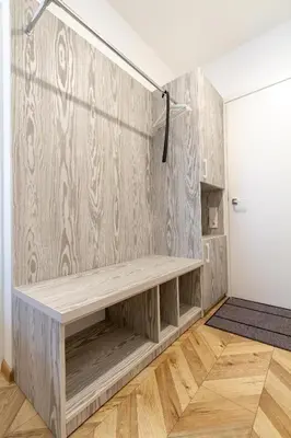 a room with a wooden wall with a bench at HOT SPOT Vilnius Apartments! in Vilnius