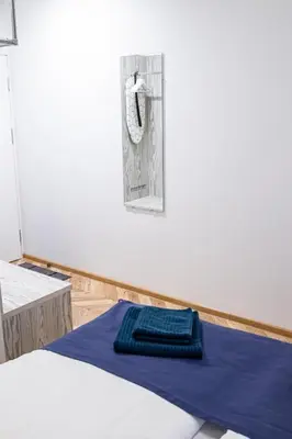 a bed with a blue towel on top of it at HOT SPOT Vilnius Apartments! in Vilnius
