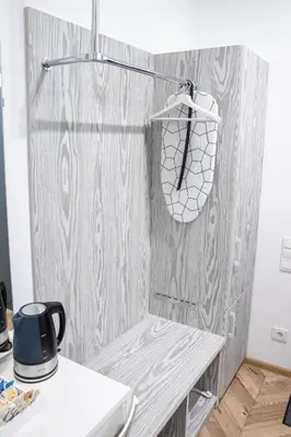 a room with a wooden wall with a table and a hat at HOT SPOT Vilnius Apartments! in Vilnius