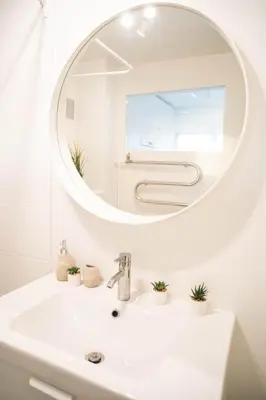 a bathroom with a white sink and a mirror at Čia gera studio in Anykščiai