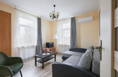 a living room with a couch and a table at Kauko Laiptu Apartment in Kaunas