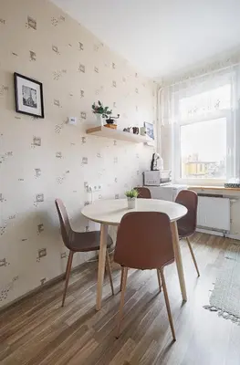 a dining room with a white table and chairs at Kauko Laiptu Apartment in Kaunas
