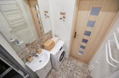 a bathroom with a toilet and a sink and a door at Kauko Laiptu Apartment in Kaunas