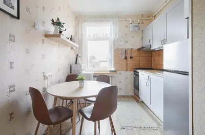 a small kitchen with a table and chairs at Kauko Laiptu Apartment in Kaunas