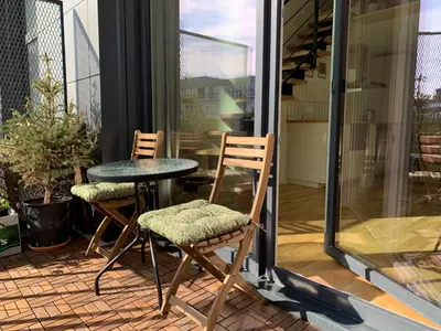 two chairs and a table on a patio at Vilnius Cozy Loft in Vilnius