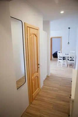 a hallway with a door and a dining room at Prie Pušyno in Birštonas
