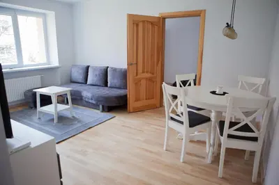 a living room with a table and a couch at Prie Pušyno in Birštonas