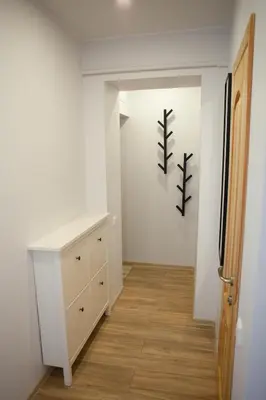 a hallway with a desk and a white wall at Prie Pušyno in Birštonas
