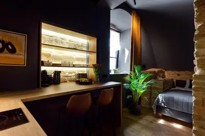a room with a counter and a bedroom with a bed at #stayhere - Historic Vilnius Old Town Chic Studio in Vilnius