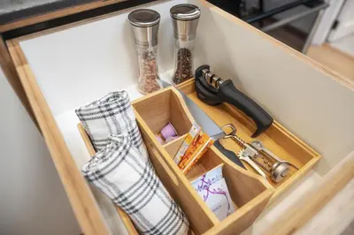 a drawer in a cabinet with a knife and utensils at TopFloor Apartments in Vilnius