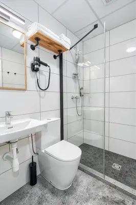 a bathroom with a toilet and a glass shower at TopFloor Apartments in Vilnius