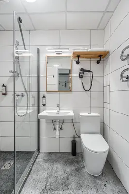 a bathroom with a toilet and a sink and a shower at TopFloor Apartments in Vilnius