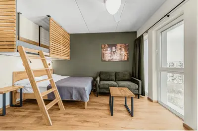 a small room with a bed and a couch at TopFloor Apartments in Vilnius