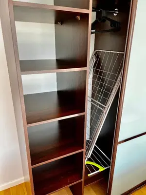 a wooden closet with wooden shelves at Vilniaus 96 apartments in Ukmergė