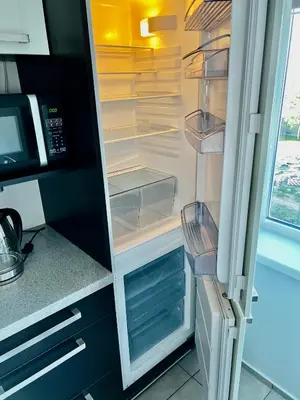 a refrigerator with its door open in a kitchen at Vilniaus 96 apartments in Ukmergė