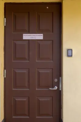 a brown door with a sign on top of it at Old Town apartments/Senamiesčio apartamentai in Ukmergė
