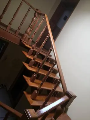 a wooden spiral staircase in a room at Green house Ramuciai in Ramučiai