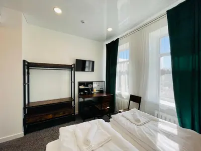 a bedroom with a bed and a mirror and a desk at Green apartments Easy Kaunas in Kaunas