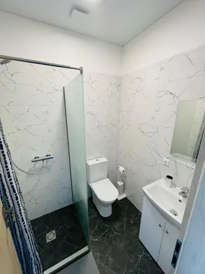 a bathroom with a toilet and a sink at Green apartments Easy Kaunas in Kaunas