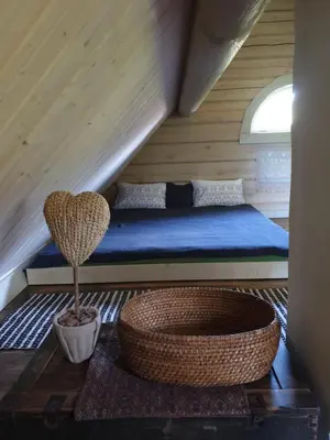 a bedroom with a bed in a attic at Amatų kalnelis in Anykščiai
