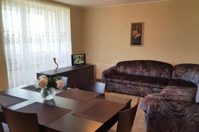 a living room with a couch and a table at Cozy apartments in Druskininkai with panorama view in Druskininkai