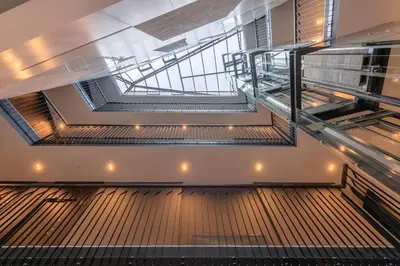 an empty room with escalators in a building at HaPPy Inn Laime Studio, Self Check-In-24-7, A-C, Parking-in-the-underground-Garage in Vilnius