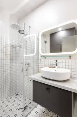 a white bathroom with a sink and a mirror at HaPPy Inn Laime Studio, Self Check-In-24-7, A-C, Parking-in-the-underground-Garage in Vilnius