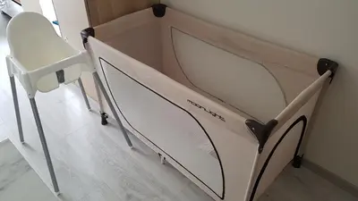 a bed in a room with a crib at HaPPy Inn Laime Studio, Self Check-In-24-7, A-C, Parking-in-the-underground-Garage in Vilnius